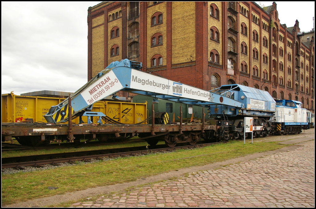 Kran 53 der Magdeburger Hafen GmbH wurde von VEB Kirow Werke Leipzig 1965 gebaut. Er hat eine Tragf�higkeit von 30 t (abgest�tzt) bzw 60 t (abgest�tzt L�ngsrichtung). Der Schienenkran wurde beim Familienfest am 09.09.2017 gezeigt und soll nach der Veranstaltung einen neuen Erhalter-Verein bekommen. Der Kran war 30 Jahre lang im Gleisbau- und Havarieeinsatz, beim Bau von Umschlagspl�tzen und beim Bau des Nordbr�ckenzugs der Stadt Magdeburg im Einsatz.