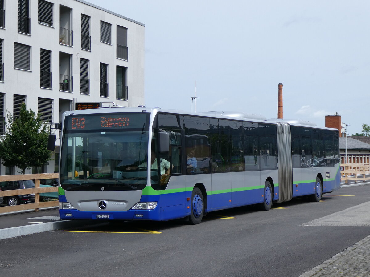 (276'213) - PostAuto Nordschweiz - BL 154'229/PID 12'420 - Mercedes (ex TPL Lugano Nr. 404) am 3. Juni 2025 beim Bahnhof Aesch