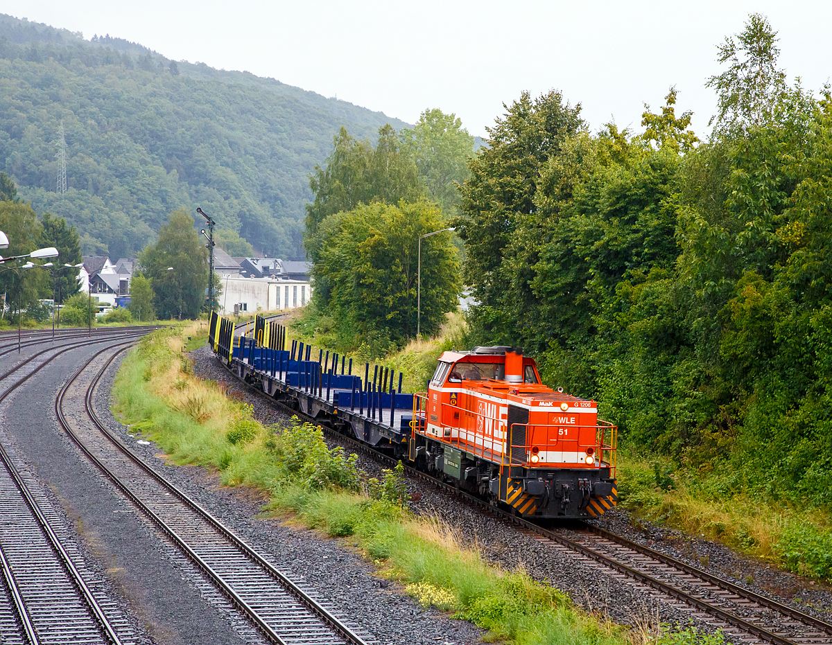 
An einem trüben regnerischen Tag im August.... 
Die WLE 51  Kreis Warendorf  eine MaK G 1206 der Westfälische Landes-Eisenbahn (92 80 1275 106-3 D-WLE) kommt mit leeren Güterzug (Schwerlastwagen) von Burbach-Holzhausen über die Hellertalbahn (KBS 462), hier am 11.08.2016 in Herdorf (km 90,5) kurz vor der Brücke Wolfsweg. Die Lok wurde 2002 bei Vossloh unter Fabriknummer 1001150 gebaut. 

Nochmals einen lieben Gruß an den freundlichen Lokführer zurück.