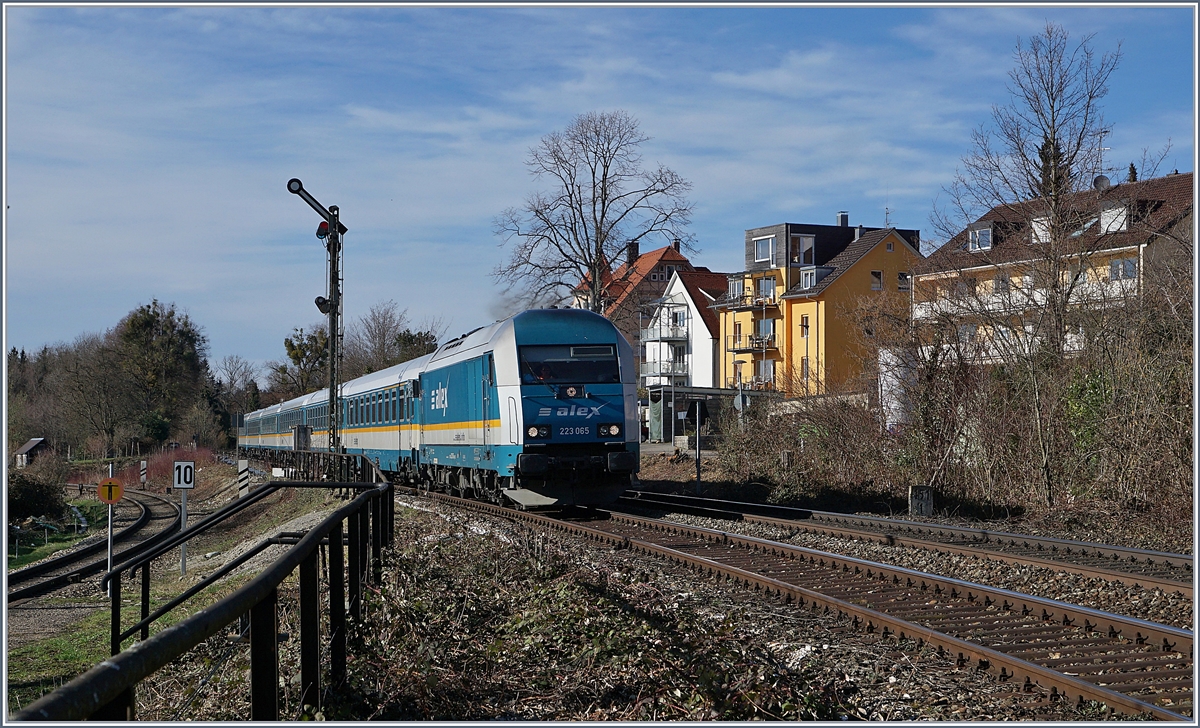 Auch Lindau Aeschbach bzw. die Abzweigung Lindau Aschbach lenkt den Lauf der Züge noch mit Formsignalen. Wahrend die Regionalbahn Züge der Bodenseegürtellinien in Lindau Aeschbach halten, scheint der über die Treppe links im Bild zugängliche  Bahnsteig  der Strecke ins Allgäu nur noch von Bahnfotografen und der Vegetation genutzt zu werden. Im Bild die 223 065 mit einem Ales von München nach Lindau, die in Lindau Aeschach frei Einfahrt hat.

16. März 2019