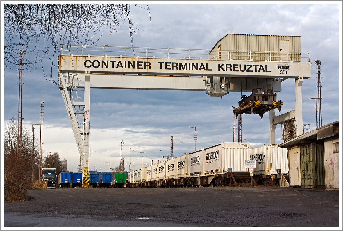 
Der Kran gehrt bald zum alten Eisen....

Noch ist der Blick frei auf das Container-Terminal Kreuztal, hier am 21.12.2013. Eigentmer von dem Terminal ist KSW Kreisbahn Siegen Wittgenstein GmbH, die dieses 1996 von der DB Cargo erworben hat. Das zurzeit nur wenig genutzte Container-Terminal Kreuztal soll sich in Krze in den wichtigsten Gterumschlagplatz der Region verwandeln.

Um das Container-Terminal in einen solchen zentralen Verladebahnhof zu verwandeln, wird bald einiges geschehen. Das rund 15 000 Quadratmeter groe Areal wird umgestaltet. Zwei Umschlaggleise und ein Abstellgleis mssen geschaffen, die Strae muss teilweise verlegt werden.

Der nicht mehr zeitgeme Portalkran wird verschwinden, da knftig zwei groe Gabelstapler, sog.  Reach Stacker , das Verladen bernehmen. Rund 10,3 Mill. Euro soll der Ausbau des Drehkreuzes kosten, 85 Prozent davon sollen aus einem Frdertopf geschpft werden.

Weil man strebt eine Betriebszulassung von 24 Stunden fr das Container-Terminal an. Dafr wird die KSW das Areal mit stattlichen Lrmschutzwnden ein hausen mssen, die insgesamt etwa 370 Meter lang und bis zu 13 Meter hoch sein werden.

Heute ist es das Sdwestfalen Container-Terminal GmbH (SWCT).
