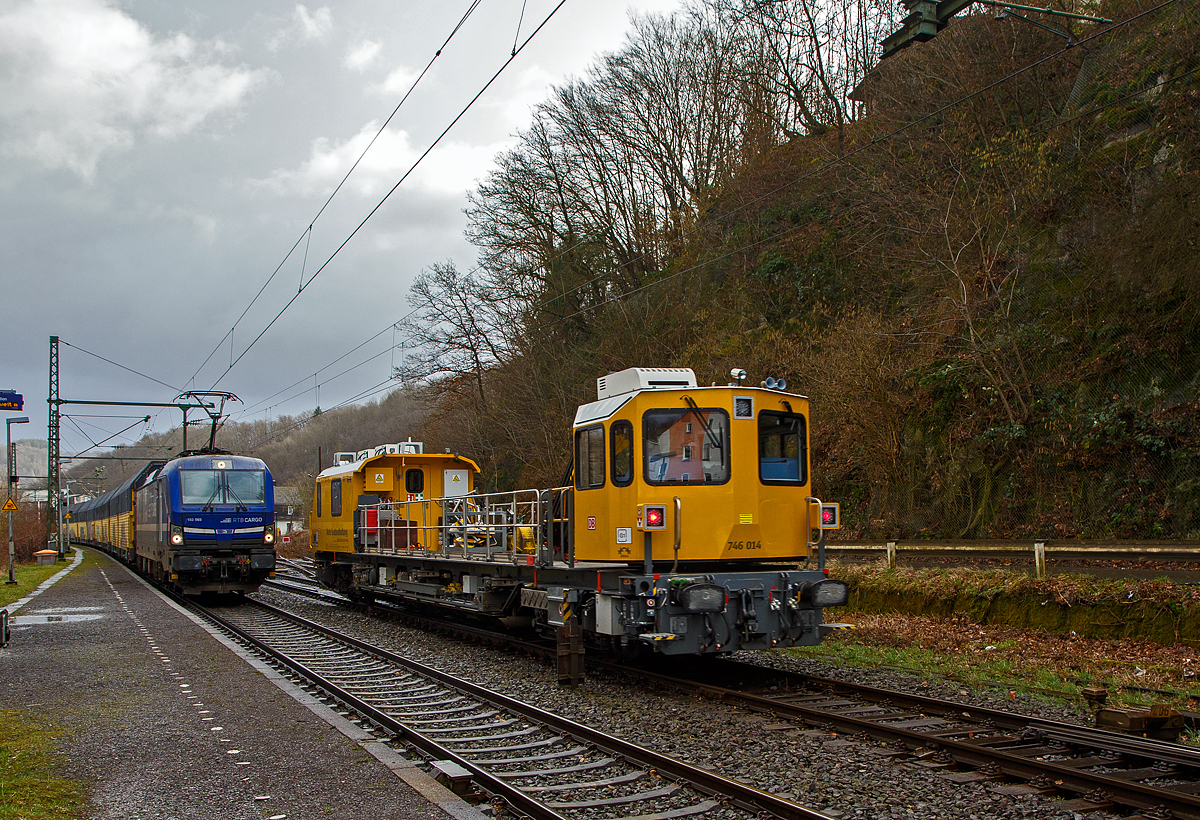 Der Orkan „Ylenia“ tobte in der Nacht vom 16. auf 17.02.2022 im Land, der Bahnverkehr ist beeinträchtigt, so war auf der Siegstrecke KBS 460 bei Niederhövels ein Baum auf die Gleise gestürzt. 

Das Gleisarbeitsfahrzeug „Hummel“ 746 014 (99 80 9110 014-4 D-DB), ein neues Plasser & Theurer GAF (der MISS-Plattform) der DB Netz AG (Netz Instandhaltung) ist am 17.02.2022 wieder auf der Rückfahrt von der Störungsstelle bei Niederhövels nach Siegen, hier fährt er durch Scheuerfeld. Das GAF war wohl für die Beseitigung des Baumes zuständig.  

Links steht noch, seit über 7 Stunden die an die RTB CARGO vermietete Siemens Vectron MS 193 565 (91 80 6193 565-9 D-ELOC) der ELL Germany GmbH (European Locomotive Leasing), mit einem sehr langen Doppelstock- Autotransportzug der ARS Altmann AG (mit Wagen der Gattung Hccrrs). Eigentlich sollte der Zug schon im Rbf Betzdorf (Sieg) stehen bleiben, aber der Zug war zu lange und hätte sonst schon eine Weiche blockiert. Da der Zug aber nicht im Rbf Betzdorf abgestellt war, durfte er nun auch (in Richtung Köln) losfahren. Der übrige Zugverkehr zwischen Siegen und Au (Sieg) wurde aber noch nicht freigegeben, da die zweite Oberleitung noch instandgesetzt werden musste.