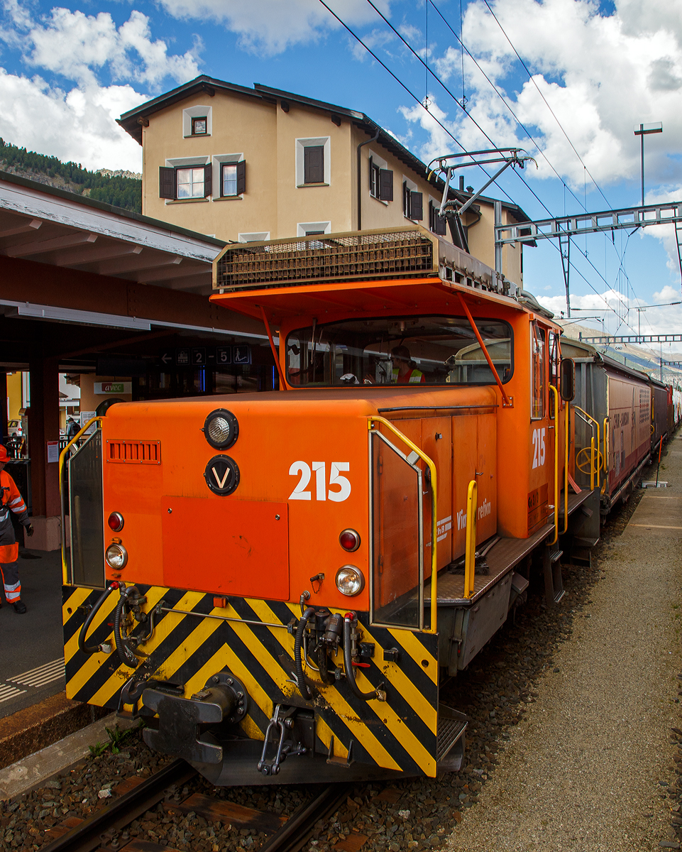 Die RhB Ge 3/3 - 215 steht am 06.09.2021 mit einem Güterzug im Bahnhof Samedan (1.705 m.ü.M.), aufgenommen aus einem Zug heraus.

Die Ge 3/3 ist eine dreiachsige elektrische Rangierlokomotive der Rhätischen Bahn (RhB). Bei der RhB zeigte sich Anfang der 1980er Jahre ein Engpass an Rangierlokomotiven, da die umgebauten und knapp 70-jährigen Ge 2/4 bedingt durch ihr Alter immer störanfälliger wurden. Ebenfalls reichte ihre Leistung nicht mehr aus, um wirtschaftlich arbeiten zu können. Die RhB entschied sich daher, gleichzeitig mit der Bestellung der zweiten Serie der Ge 4/4 II zwei moderne und leistungsfähige Rangierlokomotiven anzuschaffen.

Da man bei der ersten Serie der Ge 4/4 II gute Erfahrungen gemacht hatte, entschied man sich, die beiden Rangierlokomotiven ebenfalls in Thyristortechnik zu bauen. Die Thyristoren bilden zusammen mit Dioden einen stufenlos steuerbaren Gleichrichter, welcher den Gleichstrom-Reihenschlussmotor mit welligem Gleichstrom versorgt.

Der mechanische Teil wurde von Robert Aebi (RACO) gebaut. Der elektrische Teil stammt gleich wie bei der Ge 4/4 II von BBC. Einige Komponenten der Fahrzeuge – beispielsweise Fahrmotor, Kompressor und Vakuumpumpe – stimmen mit den entsprechenden Bauteilen der zweiten Serie Ge 4/4 II überein. Die beiden Maschinen mit den Betriebsnummern 214 (RACO Fabriknummer 1889) und 215 (RACO Fabriknummer 1899) wurden 1984 in Betrieb genommen.

TECHNISCHE DATEN:
Hersteller: RACO/ BBC
Spurweite: 1.000 mm
Achsformel: C
Länge über Puffer: 8.640 mm
Breite: 2.700 mm
Dienstgewicht: 33 t
Höchstgeschwindigkeit: 40 km/h (65 km/h Schleppfahrt)
Stundenleistung: 425 kW
Anfahrzugkraft: 102 kN
Stundenzugkraft: 60 kN bei 27 km/h
Treibraddurchmesser: 920 mm
Motorbauart: Reihenschlussmaschine
Stromsystem: 11 kV 16,7 Hz