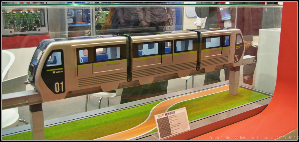 Model of Smart Monorail from Woojin Group, South Korea.

Am Messestand war ein Modell einer Monorail zu sehen, die sowohl ohne Füphrerstand (automatischer Betrieb) als auch mit Führerstand geliefert werden kann.  Die Anzahl der Module kann nach Wunsch variieren, mindestens jedoch zwei für einen Zug. Der Zug kann sowohl im Stadtverkehr, aber auch auf Ausstellungen oder Freizeitparks eingesetzt werden. Das Modell war während der InnoTrans 2014 am Stand von Woojin zu sehen.
