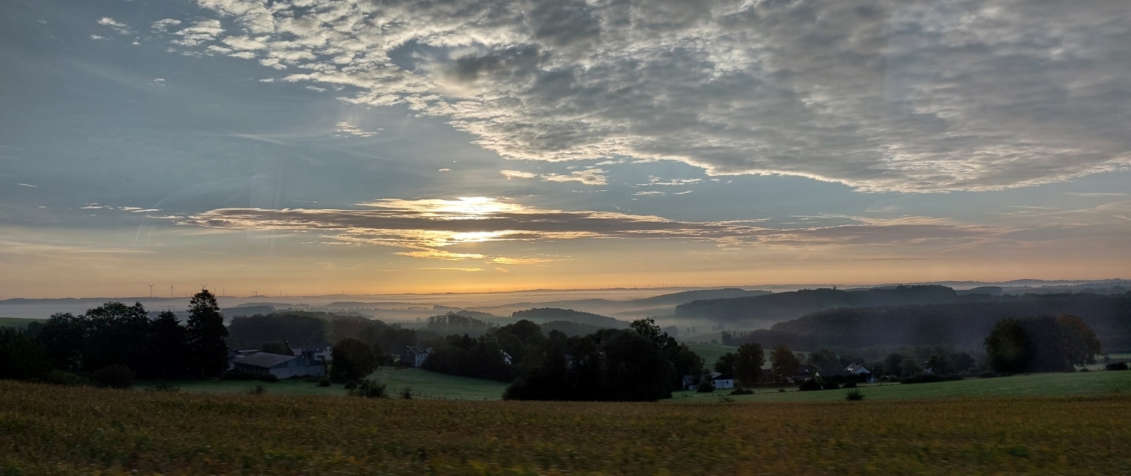 Busfahrt in den Sonnenaufgang. Kurz hinter der Belgischen Grenze steht die Sonne schon etwas h�her am Himmel aber zum Gl�ck von einer kleinen Wolke verdeckt. 06.10.2023 (Jeanny)