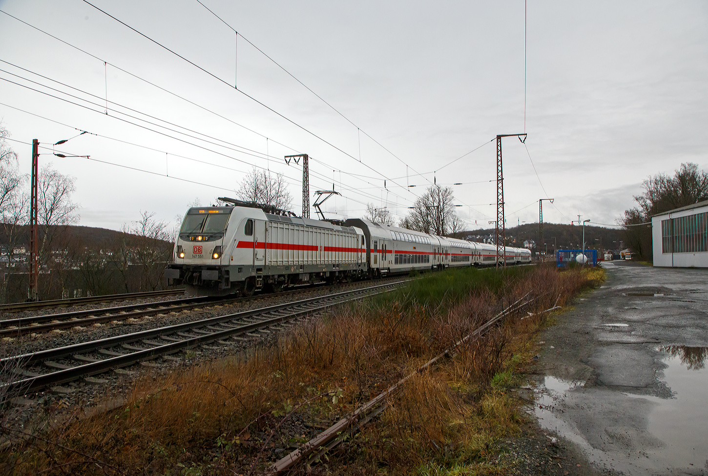 Die 147 551-6 (91 80 6147 551-6 D-DB – IC 4892) der DB Fernverkehr AG fährt am 23.12.2022, mit dem IC 2320 / RE 34 (Umlauf 52320) [Frankfurt am Main Hbf - Siegen Hbf - Dortmund Hbf] durch Rudersdorf in Richtung Siegen. Von Dillenburg bis Dortmund Hbf wird er auch als RE 34 (Umlauf 52320) geführt, es werden alle Nahverkehrsfahrkarten anerkannt.

Die TRAXX P160 AC3 wurde 2016 von Bombardier in Kassel unter der Fabriknummer KAS 35222 gebaut und an die DB Fernverkehr AG geliefert. Sie hat die Zulassungen für Deutschland. Für die Schweiz war die Zulassung auch vorgesehen, daher hat sie auch vier Stromabnehmer, doch wurde noch keine Zulassung für die Schweiz vom Hersteller erlangt. Der Bahnstrom (15.000 V 16 ⅔ Hz) ist ja derselbe, aber die Palettenbreite (Wippe) ist 1.450 mm im SBB-Netz und somit 500 mm schmaler als die Wippen fürs DB Netz (1.900 mm breit). Das Schleifleistenmaterial ist bei beiden aus Graphit.