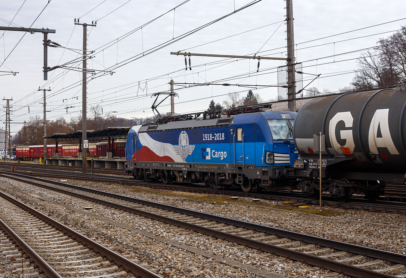 Die 383 009-8 (91 54 7383 009-8 CZ-CDC) der ČD Cargo a.s. (Praha/Prag) fährt am 14 Januar 2025, mit einem mit Diesel oder Heizöl beladenen Kesselwagenzug, durch den Bahnhof Attnang-Puchheim auf den Westbahn in östlicher Richtung. Die Siemens Vectron MS trägt hier Werbung 100 Jahre „1918 – 2018“ Tschechische Bahn bzw. (ursprünglichen) Tschechoslowakische Staatsbahnen. 

Die Multisystemlokomotive Siemens Vectron MS wurde 2018 von Siemens Mobilitiy in München-Allach unter der Fabriknummer 22461 gebaut. Sie wurde in der Variante A01-1d ausgeführt und hat so die Zulassung für Tschechien, Deutschland, Österreich, Slowakei, Polen, Ungarn und Rumänien (D / A / SK / PL / CZ / H + RO). So besitzt die Vectron Variante MS A01 folgende Zugsicherungssysteme: ETCS BaseLine 3, sowie für Deutschland (PZB90 / LZB80 (CIR-ELKE I)), für Österreich (ETCS Level 1 mit Euroloop, ETCS Level 2, PZB90 / LZB80), für Polen (SHP), Slowakei und Tschechien (LS (Mirel)), Ungarn (ETCS Level 1, EVM (Mirel)) und Rumänien (PZB90).