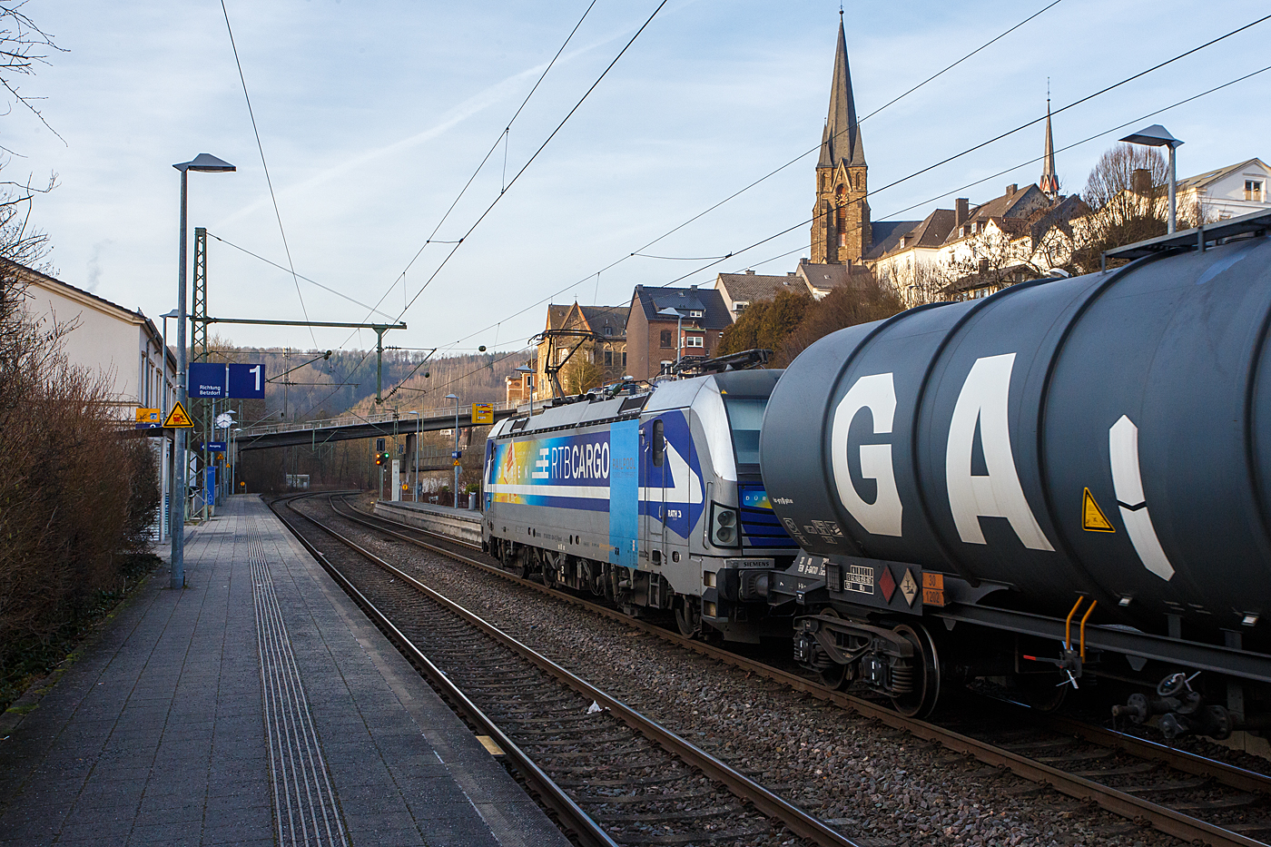 Die für die Rurtalbahn Cargo GmbH fahrende Vectron 193 824-0  Düren  (91 80 6193 824-0 D-Rpool) der Railpool fährt am 22 Januar 2026 mit einem Kesselwagenzug durch Kirchen/Sieg in Richtung Siegen. Laut Gefahrgut- Warntafeln 30/1202 waren die Wagen mit Dieselkraftstoff oder leichtem Heizöl beladen.

Die SIEMENS Vectron AC (200 km/h - 6.4 MW) wurde 2016 von SIEMENS Mobilitiy in München-Allach unter der Fabriknummer 22054 gebaut. Sie hat die Zulassung für D, A, H und RO.